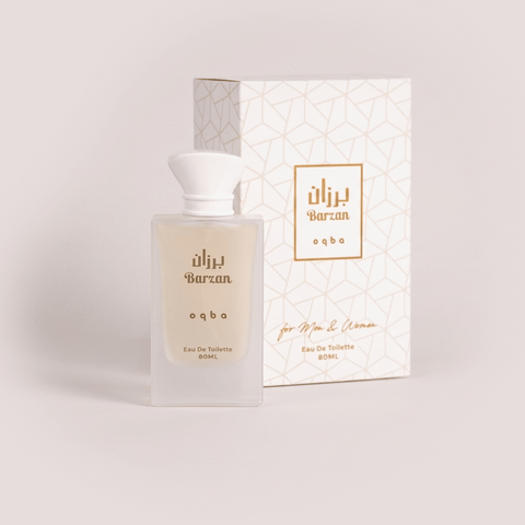 Perfume bottle and packaging with 'alihi Barzan' branding on a light gray background
