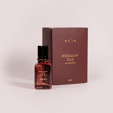 Rosemary Oud perfume bottle and packaging on a light pink background