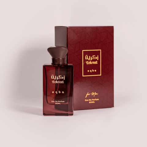 Red perfume bottle and packaging with gold text on a light gray background